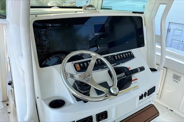 Slide: The Image of 2016 Hydra-Sports 3400 CC boat dashboard with steering wheel and control panel. - 7