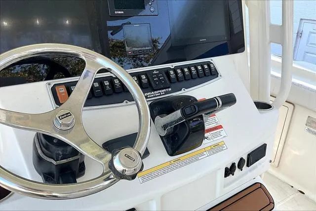 Slide: The Image of 2016 Hydra-Sports 3400 CC boat dashboard with steering wheel and controls. - 9