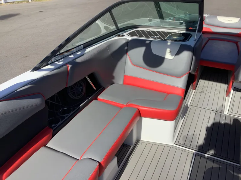 Slide: The Image of 2019 Nautique GS24 boat interior with gray and red seating, sleek design. - 18