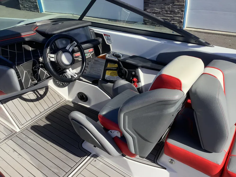 Slide: The Image of 2019 Nautique GS24 boat interior with modern dashboard and seating. - 19