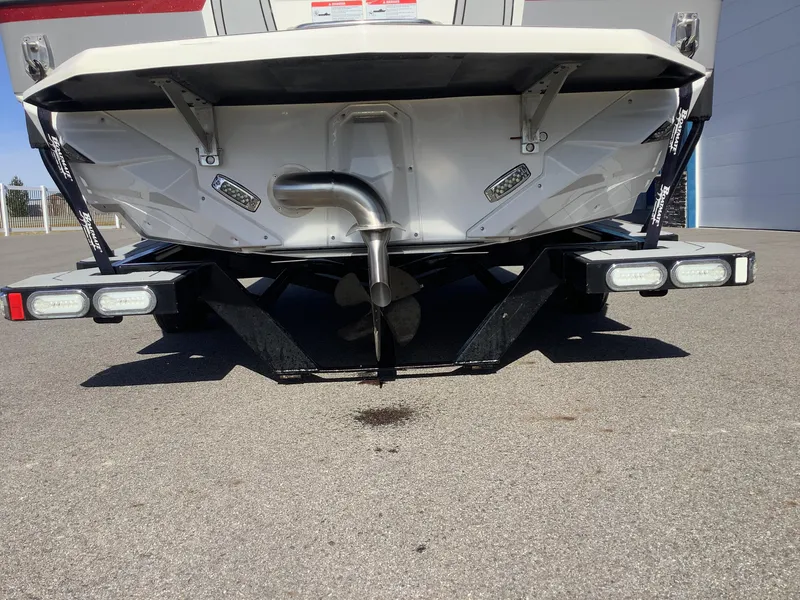 Slide: The Image of 2019 Nautique GS24 boat rear view, showcasing exhaust and trailer lights. - 9