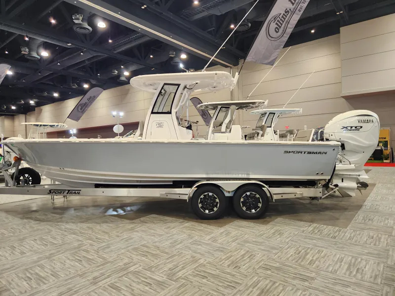 The Image of 2025 Sportsman Masters 267OE Bay Boat displayed indoors on a trailer. - 0