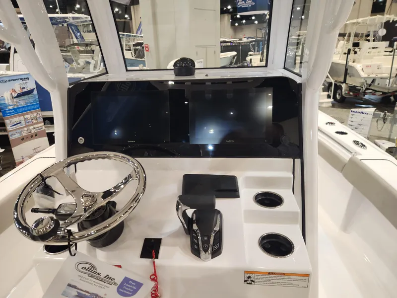 Slide: The Image of 2025 Sportsman Masters 267OE Bay Boat dashboard with steering wheel and controls. - 12