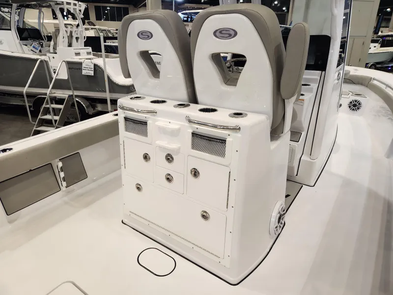 Slide: The Image of 2025 Sportsman Masters 267OE Bay Boat interior with dual seats and storage console. - 14