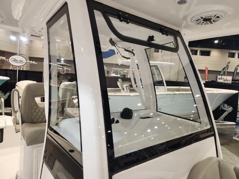 Slide: The Image of 2025 Sportsman Masters 267OE Bay Boat interior at a boat show display. - 16