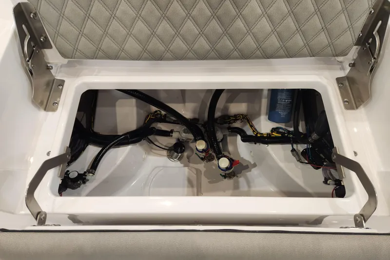 Slide: The Image of 2025 Sportsman Masters 267OE Bay Boat storage compartment with wiring and components. - 19