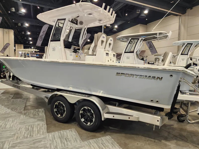 Slide: The Image of 2025 Sportsman Masters 267OE Bay Boat on display in an indoor showroom. - 2