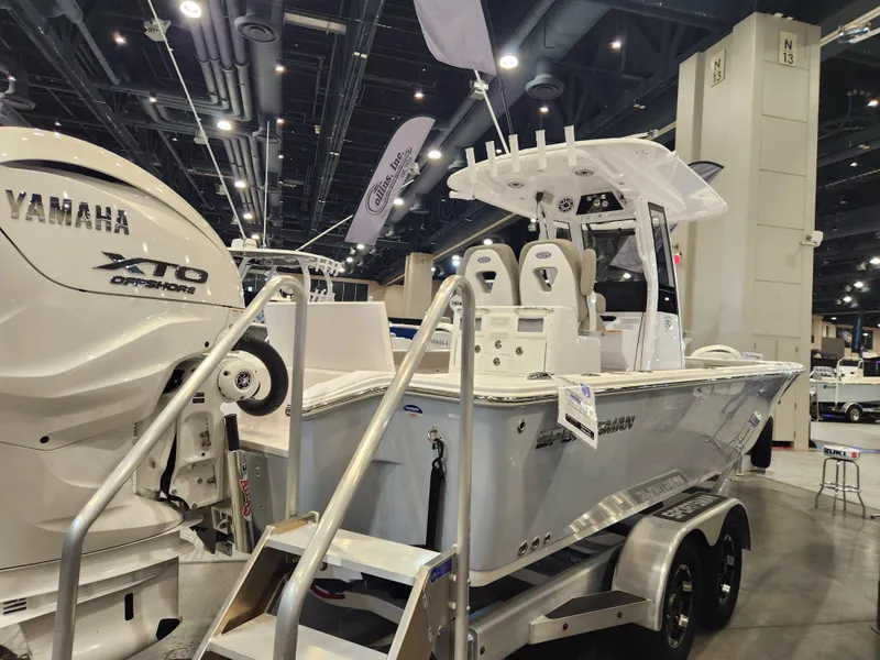 Slide: The Image of 2025 Sportsman Masters 267OE Bay Boat displayed indoors with Yamaha XTO engine. - 3