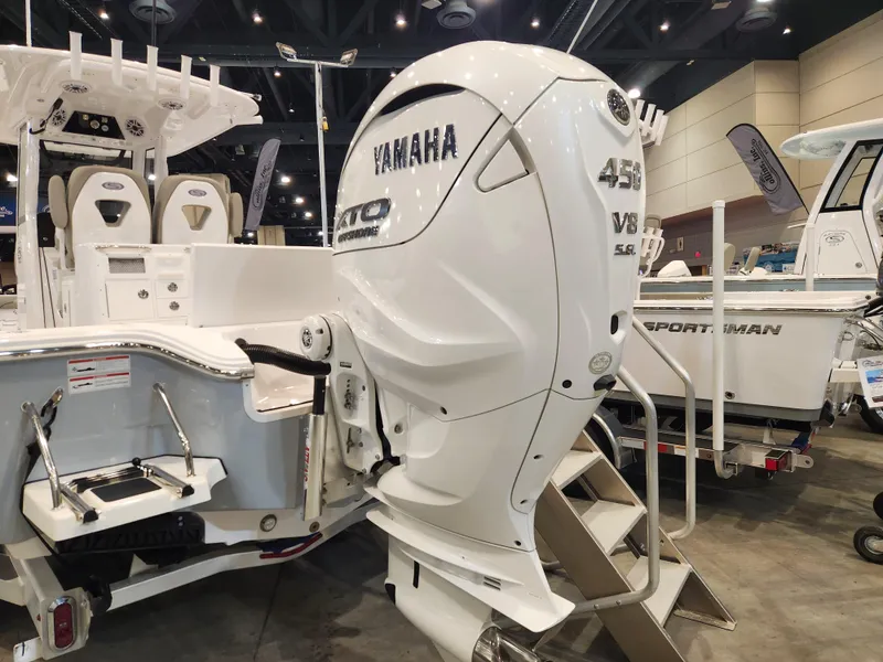 Slide: The Image of 2025 Sportsman Masters 267OE Bay Boat with Yamaha 450 V8 engine at a boat show. - 4