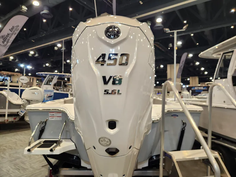 Slide: The Image of 2025 Sportsman Masters 267OE Bay Boat with 450 V8 5.6L engine at a boat show. - 5