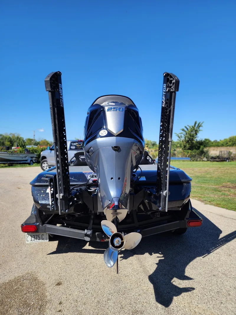 Slide: The Image of 2024 Skeeter FXR21LE boat with powerful outboard motor, parked on a sunny day. - 3