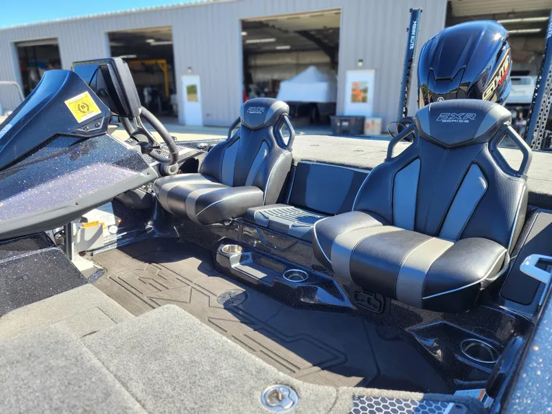 Slide: The Image of 2024 Skeeter FXR21LE boat interior with sleek black seats and modern dashboard design. - 6