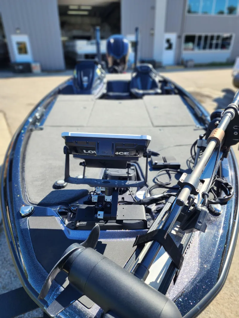 Slide: The Image of 2024 Skeeter FXR21LE fishing boat with advanced navigation equipment, docked outdoors. - 7