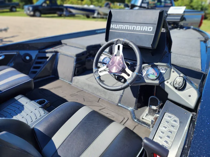 Slide: The Image of 2024 Skeeter FXR21LE boat interior with Humminbird navigation system and steering wheel. - 8