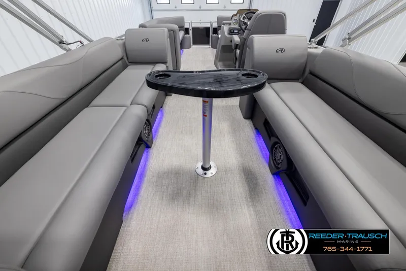 Slide: The Image of 2025 Avalon VLS QL boat interior with gray seating and blue LED lighting. - 17