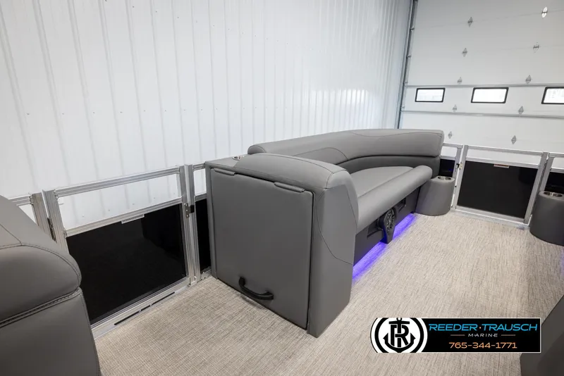 Slide: The Image of 2025 Avalon VLS QL pontoon boat interior with gray seating and blue LED lighting. - 21