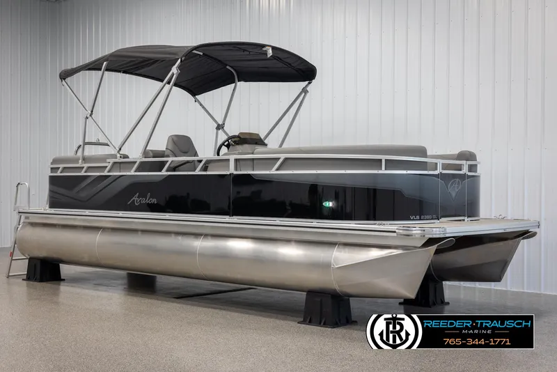 Slide: The Image of 2025 Avalon VLS QL pontoon boat with canopy in showroom. - 3