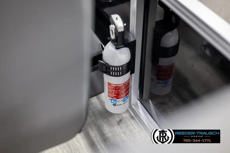Slide: The Image of Fire extinguisher mounted inside Avalon VLS QL 2025 vehicle, Reeder-Trausch Marine branding visible. - 36