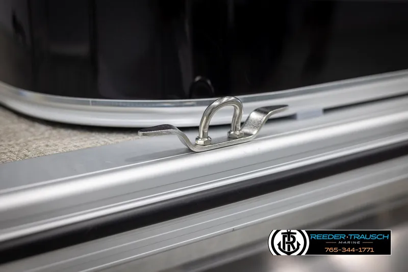 Slide: The Image of Close-up of 2025 Avalon VLS QL boat cleat on deck, Reeder-Trausch Marine logo visible. - 49