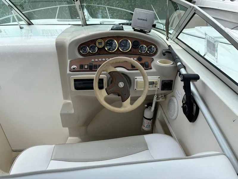 Slide: The Image of Cockpit of 2000 Rinker 242 Fiesta V boat with steering wheel and instrument panel. - 5