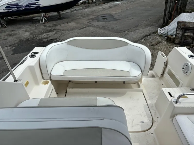 Slide: The Image of 2000 Rinker 242 Fiesta V boat interior with white seating and deck area. - 6