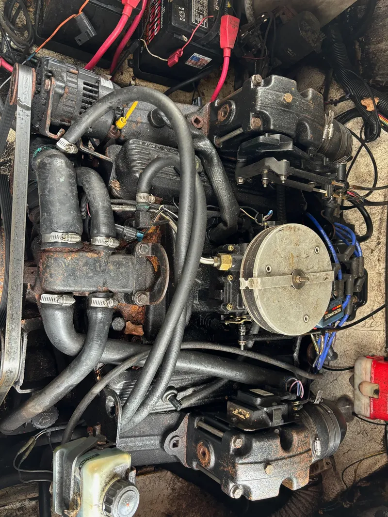 Slide: The Image of Engine of a 2000 Rinker 242 Fiesta V boat with visible components and wiring. - 7