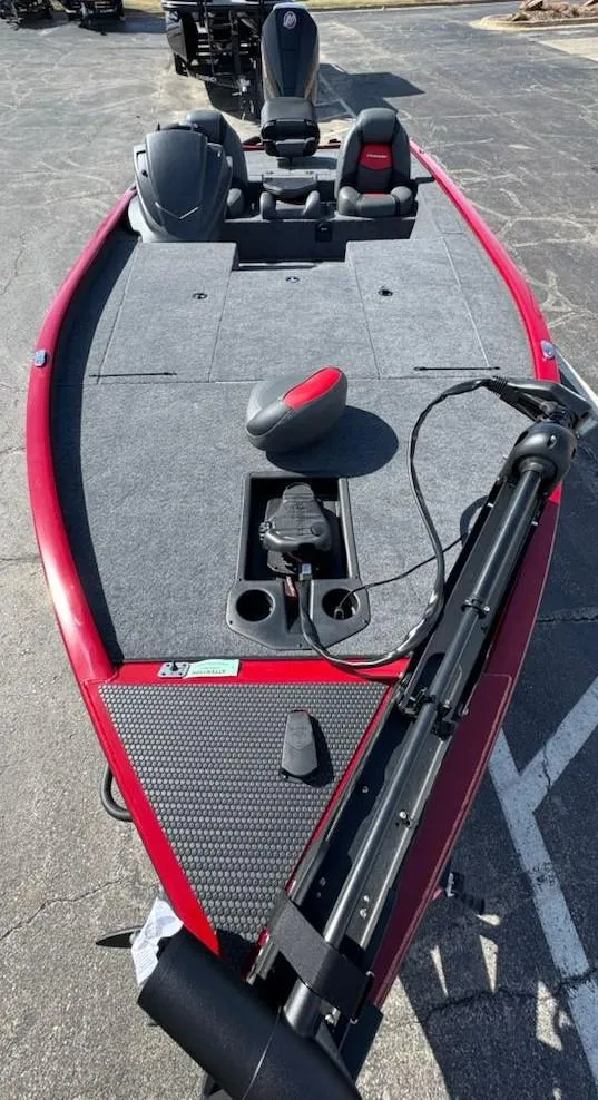 Slide: The Image of 2025 Tracker Savage 215 boat, red and gray deck, equipped with seating and trolling motor. - 10