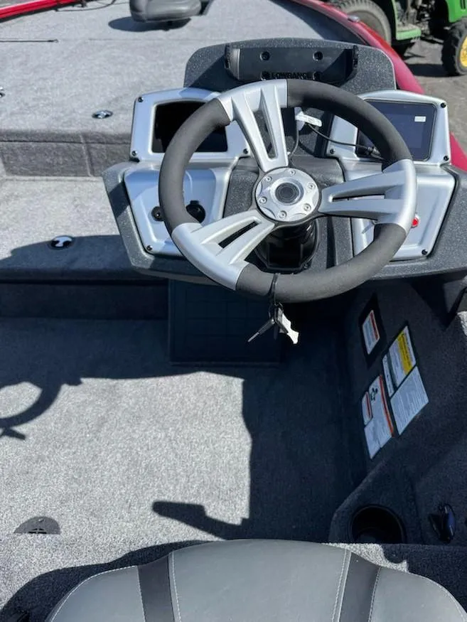 Slide: The Image of Steering wheel of 2025 Tracker Savage 215 boat, featuring modern design and controls. - 11