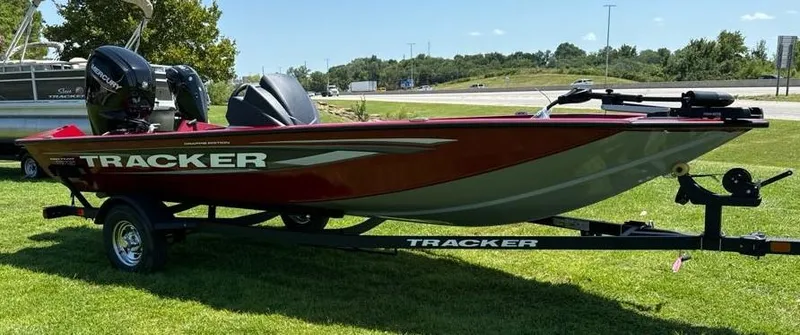 Slide: The Image of 2025 Tracker Savage 215 boat on trailer, parked on grass, sunny day. - 3