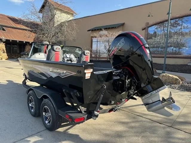 Slide: The Image of 2025 Ranger VS1882SC Angler boat with powerful outboard motor, parked outdoors. - 2