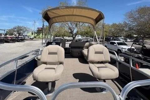 Slide: The Image of 2025 Sun Tracker Bass Buggy 16 XL Select pontoon boat with canopy and seating. - 2