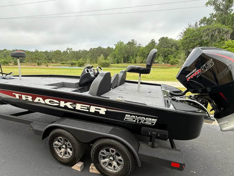 Slide: The Image of 2025 Tracker Savage 215 boat on trailer, featuring sleek design and powerful engine. - 2