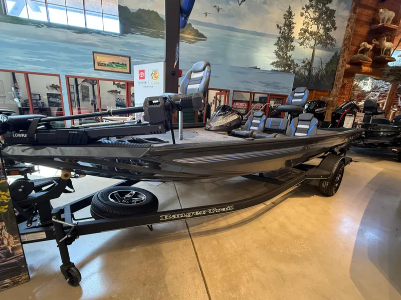 Slide: The Image of 2025 Ranger RT178 boat displayed indoors with scenic backdrop. - 0