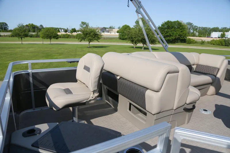 Slide: The Image of 2025 Sun Tracker Fishin' Barge 20 DLX interior with beige seating and open deck. - 4