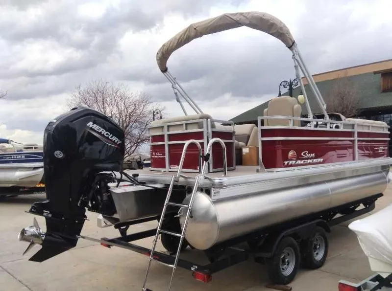 Slide: The Image of 2025 Sun Tracker Party Barge 20 DLX pontoon boat with Mercury engine on trailer. - 4