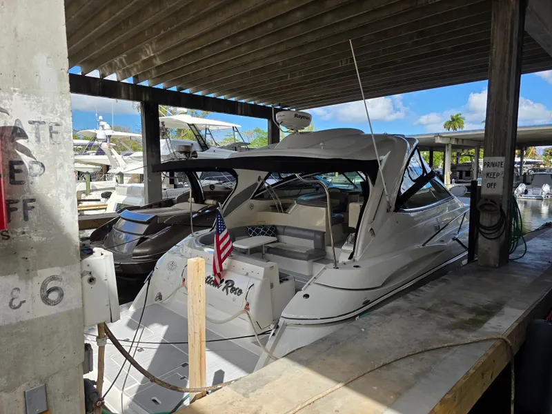 Slide: The Image of 2007 Cruisers Yachts 460 Express docked in a marina under a covered area. - 1