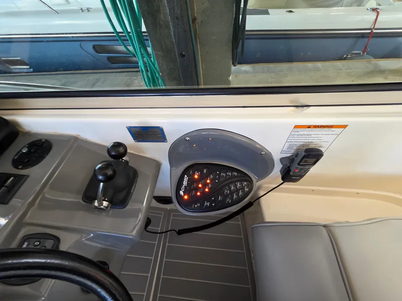 Slide: The Image of 2007 Cruisers Yachts 460 Express helm controls and dashboard detail. - 10
