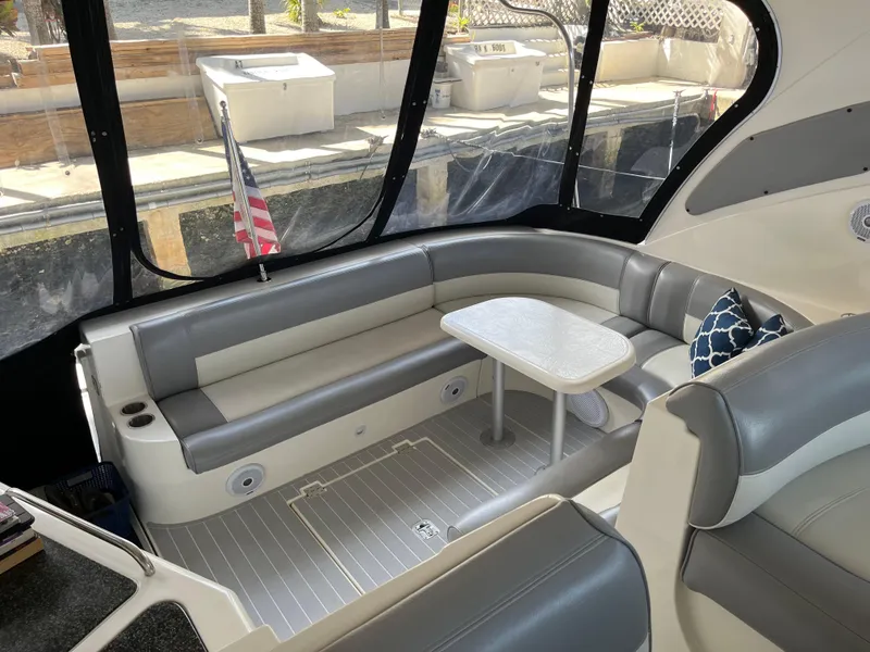 Slide: The Image of 2007 Cruisers Yachts 460 Express interior with seating, table, and American flag. - 11