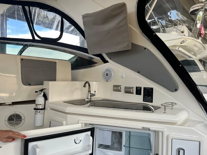 Slide: The Image of 2007 Cruisers Yachts 460 Express interior with kitchenette and open fridge. - 14