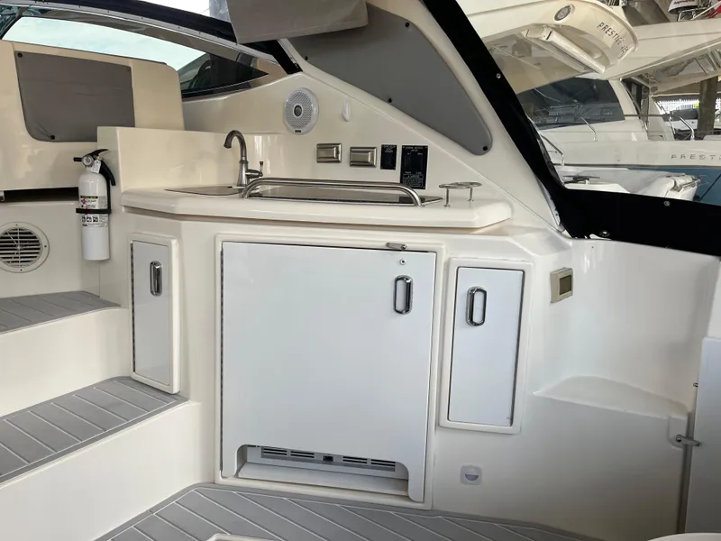 Slide: The Image of 2007 Cruisers Yachts 460 Express interior with kitchenette and modern amenities. - 16