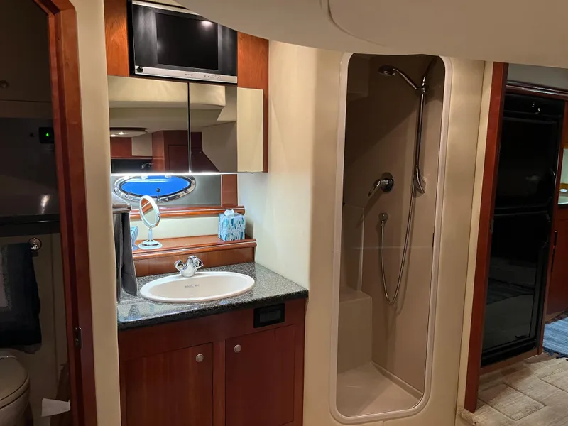Slide: The Image of 2007 Cruisers Yachts 460 Express bathroom with sink, mirror, and shower. - 27