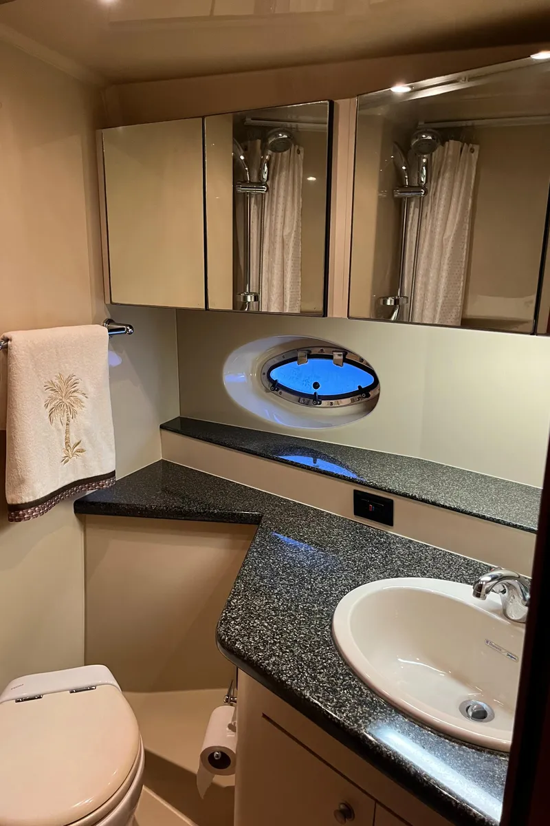 Slide: The Image of 2007 Cruisers Yachts 460 Express bathroom with modern fixtures and porthole window. - 33