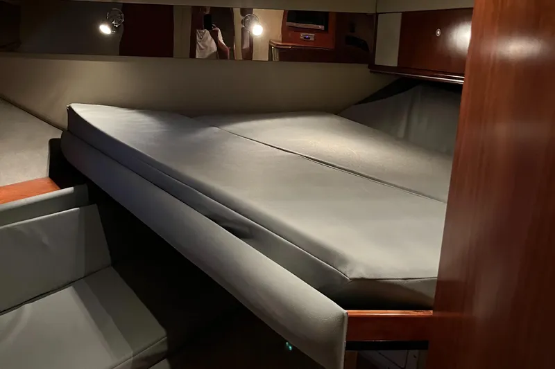 Slide: The Image of 2007 Cruisers Yachts 460 Express interior cabin with bed and seating area. - 34