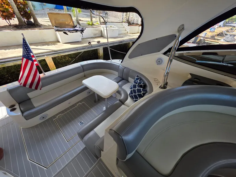 Slide: The Image of 2007 Cruisers Yachts 460 Express interior with seating, table, and American flag. - 6