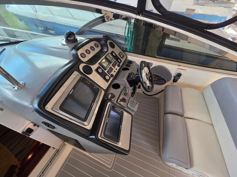 Slide: The Image of 2007 Cruisers Yachts 460 Express helm with modern navigation controls and seating. - 8