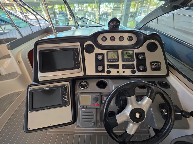 Slide: The Image of Helm of 2007 Cruisers Yachts 460 Express with navigation instruments and steering wheel. - 9