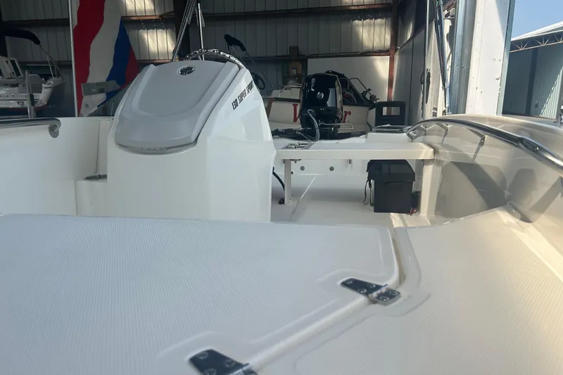 Slide: The Image of 2025 Boston Whaler 130 Super Sport boat interior in a storage facility. - 3
