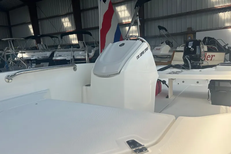 Slide: The Image of 2025 Boston Whaler 130 Super Sport boat interior in a storage facility. - 4