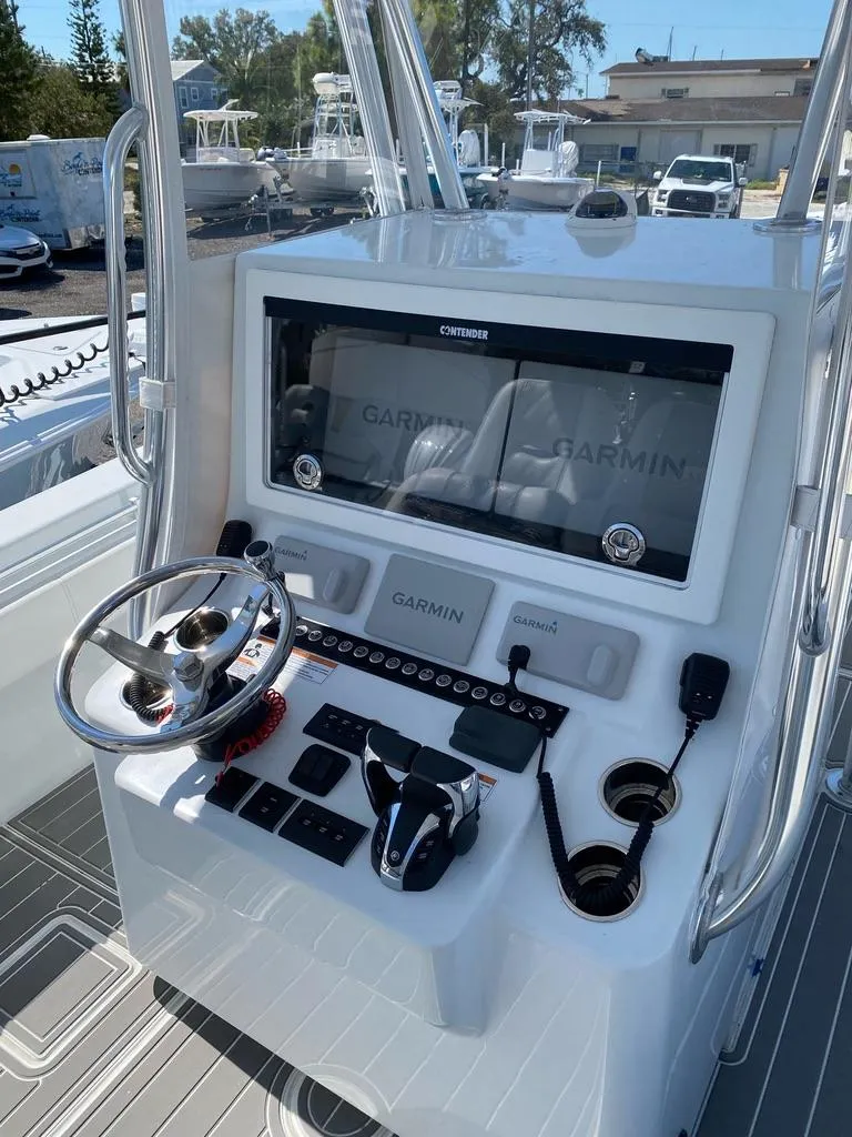 Slide: The Image of 2023 Contender 35ST boat console with Garmin navigation system and steering wheel. - 6