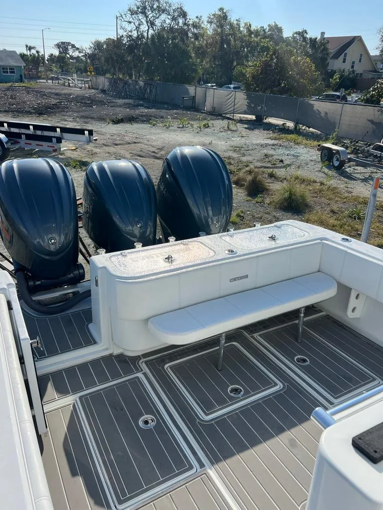 Slide: The Image of 2023 Contender 35ST boat with triple outboard engines and spacious deck seating. - 8